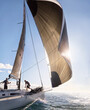 © KOTO - Wind pulling sail on sailboat on sunny ocean