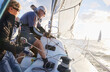 © KOTO - Retired couple sailing pulling rigging on sailboat