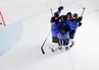 Hockey team in blue uniforms cheering celebrating on ice