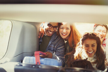 Canvas Print - Friends unloading cooler from back of car