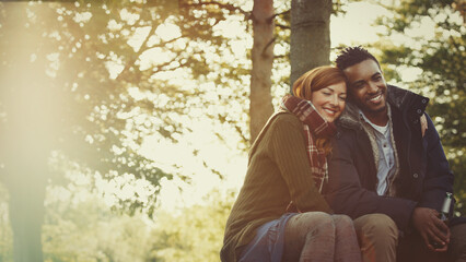 Wall Mural - Affectionate couple hugging and drinking beer in woods