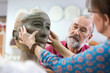 Woman sculpting clay face in pottery studio
