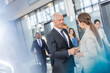 © KOTO - Business people greeting shaking hands in airport