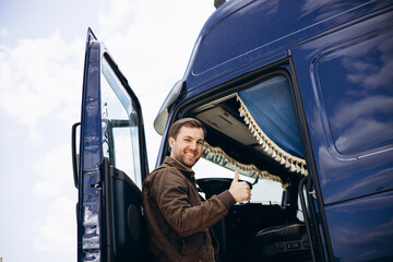 Wall Mural - Truck driver standing by his lorry