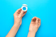© Pixel-Shot - Woman holding dental floss on blue background