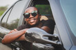 © arrowsmith2 - Handsome young African man in sunglasses while driving on his vacation trip