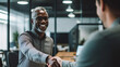© annebel146 - Business, career and placement concept successful young man smiling and handshaking with european businessman after successful negotiations or interview in office
