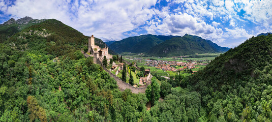 Wall Mural - Medieval castles of northern Italy, Trentino Alto Adige region. Aerial panoramic view of Castello di Avio and village surrounded by Alps mountains