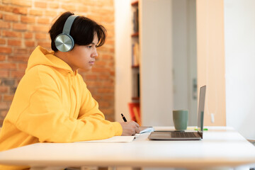 Sticker - Serious japanese guy having video conference on laptop at home