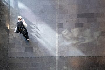 Wall Mural - top aerial view man tourist people walk on across pedestrian concrete. concept of social still life.