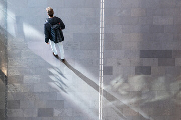 Wall Mural - top aerial view man tourist people walk on across pedestrian concrete. concept of social still life.