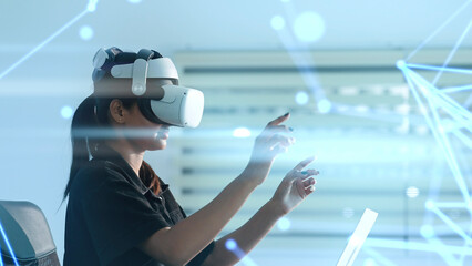Women wearing VR goggles posing finger pointing and touching on the air connecting to internet metaverse system with holographic screen. Digital technology of the future. Virtual reality concept