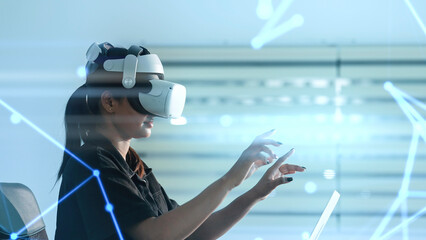 Women wearing VR goggles posing finger pointing and touching on the air connecting to internet metaverse system with holographic screen. Digital technology of the future. Virtual reality concept