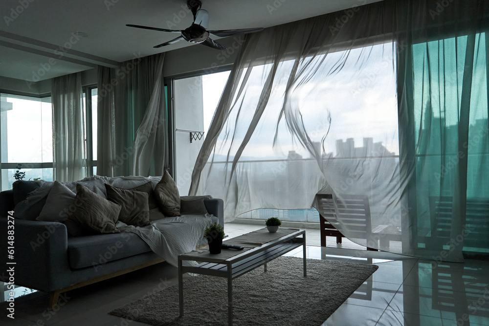 The Wind Rustles The wind rustles the curtain of the panoramic window with a cityscape ...