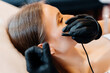 © Anastasiia Bielokon - Close up view of doctor is doing electroepilation to the client, using electro needle and tweezers. Hair removal procedure, professional beauty care. Beautcian's hands in gloves. High quality photo