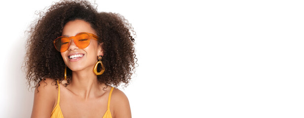 Very attractive young woman with afro hairstyle and yellow dress on isolated white background.