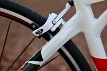 Bicycle Frame Detail With Rear Brake Caliper, Rear Wheel, Spokes And Tire (close Up Of White Painted Aluminum Bicycle Frame) Road Bike With 700c Wheels, Unique Construction