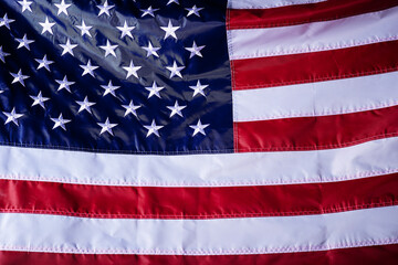 Wall Mural - closeup shot of the waving flag of the United States of America with interesting textures