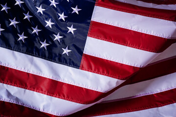 Wall Mural - closeup shot of the waving flag of the United States of America with interesting textures