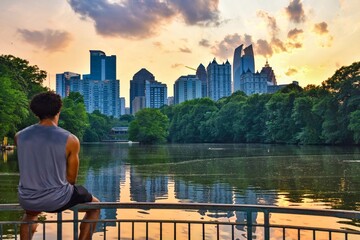 An unrecognizable young man enjoying a Sunset in Piedmont Park, Midtown Atlanta 