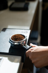 Wall Mural - Barista preparing coffee in a coffee machine, close-up.