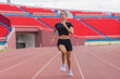 © Mongkolchon - Asian female athlete accelerates during her speed running practice on the stadium track, embodying determination