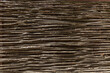 Fence made of dry brown rods. Background, space for text. Close-up.