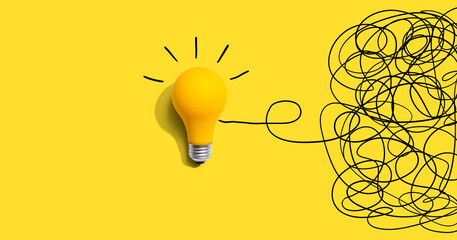 clarifying complex ideas theme with light bulb - flat lay