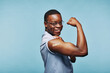 © Flamingo Images - African man flexing after a vaccination