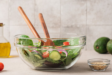 Wall Mural - Fresh green lettuce leaves mix in glass bowl. Cooking healthy and delicious food. Diet food concept