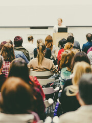 Wall Mural - business and entrepreneurship symposium. female speaker giving a talk at business meeting. audience 