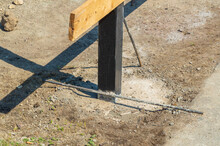 Installation Of A New Fence. The Post Is Dug Into The Ground And Filled With Concrete