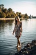 shot of an attractive young woman strolling along by the water, created with generative ai