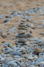 Zen stones balance on a rocky beach