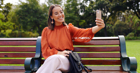 Poster - Selfie, smile and Asian woman on bench at park taking pictures for social media. Summer, profile picture and person sitting outdoor taking photo for happy memory, tongue out or funny face alone.