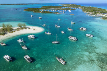 Wall Mural - Drone aerial view of anchored sailing yacht in emerald Caribbean Sea, Stocking Island, Great Exuma, Bahamas.