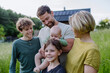 © Halfpoint - Happy family near their house with solar panels. Alternative energy, saving resources and sustainable lifestyle concept.