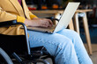 © WavebreakMediaMicro - Midsection of plus size caucasian casual businesswoman in wheelchair using laptop in office