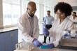 © ReeldealHD images - Scientists studying test samples together in a laboratory