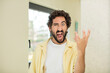 © kues1 - young crazy bearded man looking angry, annoyed and frustrated screaming wtf or what’s wrong with you