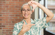 © kues1 - senior pretty woman feeling happy, friendly and positive, smiling and making a portrait or photo frame with hands