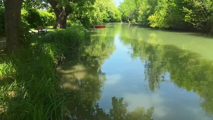 canoe and reflection of trees in the water