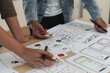 © itchaznong - Close up ux developer and ui designer brainstorming interface wireframe design.Creative digital development agency