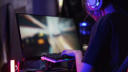 female cyber hacker gamer pressing on keyboard to competition and playing games on computer