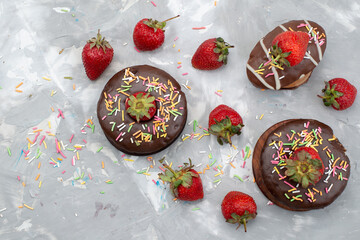 Wall Mural - a top view little chocolate donut with designed and fresh fruits on top on the grey background sweet sugar cake fruit cacao