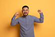 © Prostock-studio - Big Luck. Overjoyed Young Asian Man Celebrating Success With Raised Fists