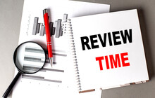 REVIEW TIME Text Written On Notebook With Chart