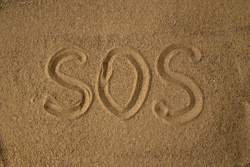 Wall Mural - top view of sos warning made on a brown sand death funeral palestine israel