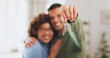 © Azee/peopleimages.com - Hand, keys and a home owner couple proud of their real estate property investment or purchase. House, mortgage or beginning with a blurred background man and woman together in their new apartment