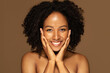 © Prostock-studio - Beautiful young black woman touching her pretty face and smiling